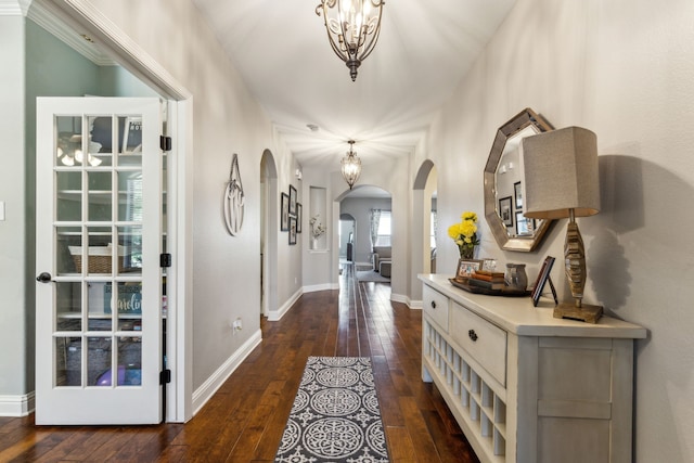 1250 Amistad Dr, Prosper, TX 75078 - foyer with arched walkways, dark wood-style floors, baseboards, and a chandelier