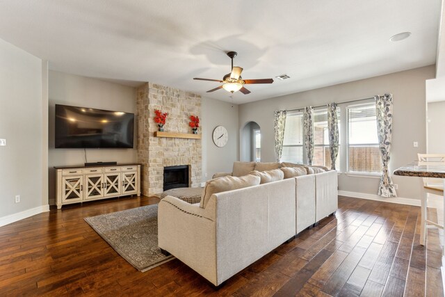 1250 Amistad Dr, Prosper, TX 75078 - living room with baseboards, arched walkways, ceiling fan, and dark wood-type flooring