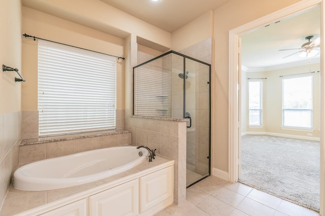 full bath featuring a garden tub, a shower stall, ceiling fan, tile patterned floors, and ornamental molding