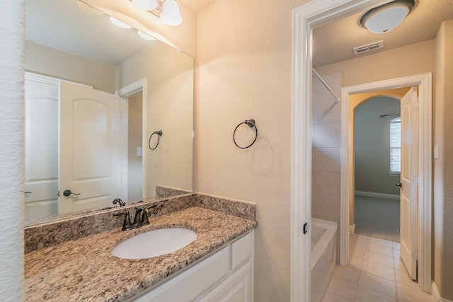 bathroom featuring tile patterned flooring, vanity, and bathtub / shower combination