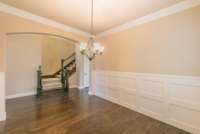unfurnished dining area with a chandelier, stairway, arched walkways, dark wood finished floors, and ornamental molding