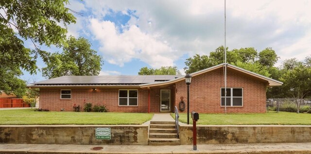 405 W Neely Ave, Comanche, TX 76442 - ranch-style home with roof mounted solar panels and brick siding
