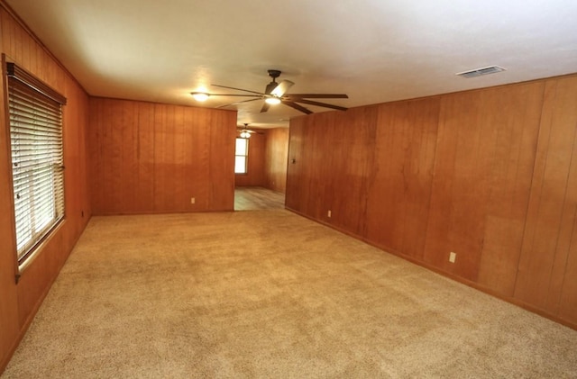 405 W Neely Ave, Comanche, TX 76442 - empty room featuring carpet, ceiling fan, and wood walls