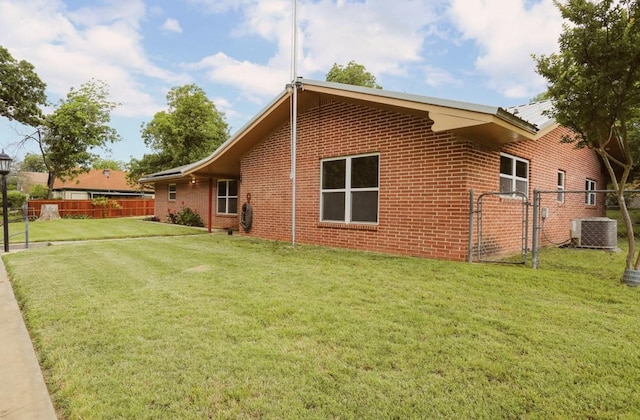 405 W Neely Ave, Comanche, TX 76442 - view of home's exterior featuring brick siding, central air condition unit, and a gate