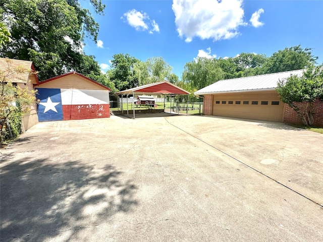 405 W Neely Ave, Comanche, TX 76442 - garage with driveway and a carport