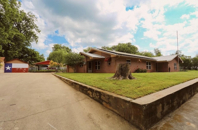 405 W Neely Ave, Comanche, TX 76442 - view of front of property with a front yard, brick siding, and a detached garage