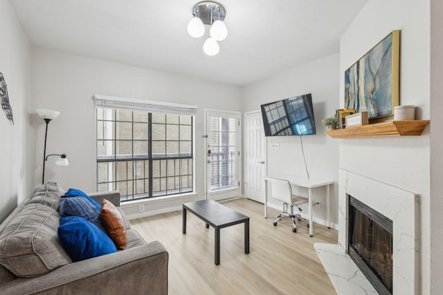 4800 W Lovers Ln Unit 113, Dallas, TX 75209 - living area featuring light wood-type flooring, plenty of natural light, and a high end fireplace