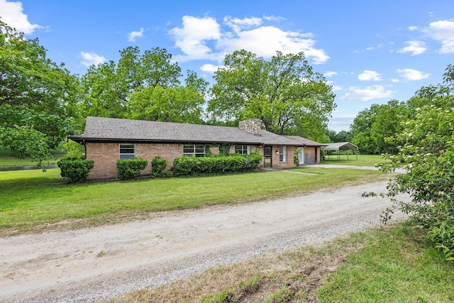531 Eisenhower Rd, Denison, TX 75020 - ranch-style house featuring dirt driveway, an attached garage, a chimney, a front lawn, and brick siding