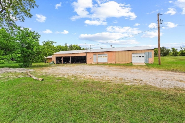 531 Eisenhower Rd, Denison, TX 75020 - back of property with a detached garage, a lawn, an outbuilding, a pole building, and dirt driveway