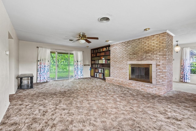 531 Eisenhower Rd, Denison, TX 75020 - unfurnished living room featuring carpet flooring, a fireplace, ceiling fan, baseboards, and built in shelves