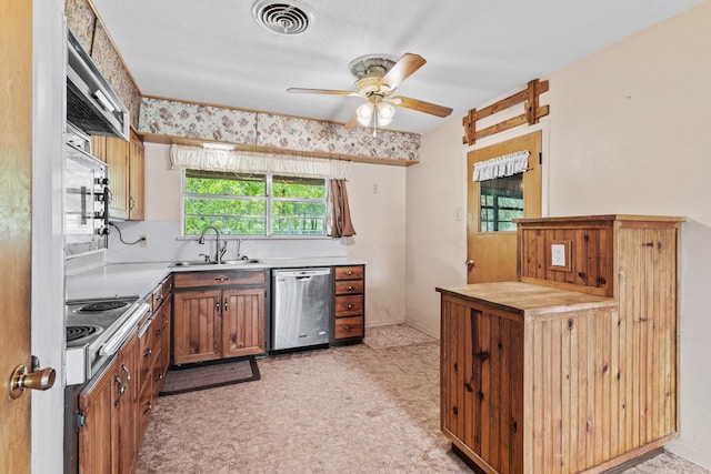 531 Eisenhower Rd, Denison, TX 75020 - kitchen with stainless steel appliances, a sink, ceiling fan, light countertops, and light floors