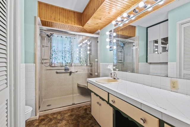 531 Eisenhower Rd, Denison, TX 75020 - full bath with a shower stall, vanity, toilet, wainscoting, and tile walls