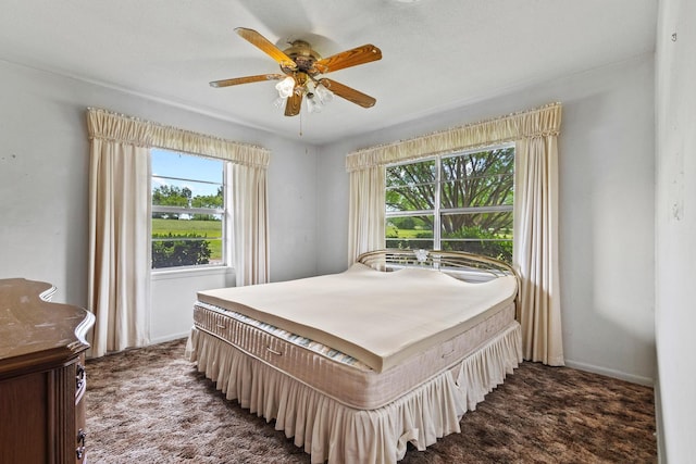 531 Eisenhower Rd, Denison, TX 75020 - bedroom featuring dark carpet, a ceiling fan, and baseboards