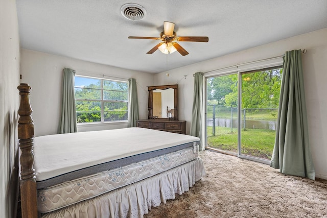 531 Eisenhower Rd, Denison, TX 75020 - carpeted bedroom featuring access to exterior, ceiling fan, and a water view