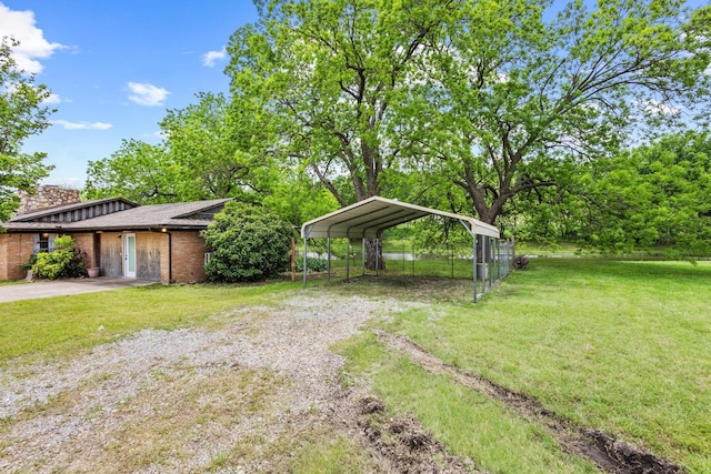 531 Eisenhower Rd, Denison, TX 75020 - view of green lawn featuring driveway and a detached carport