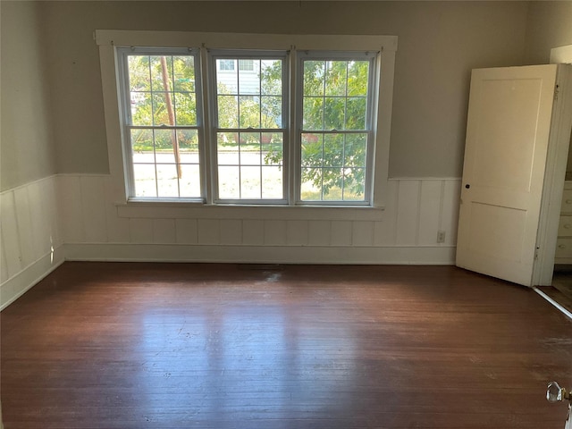 118 S 31st St, Corsicana, TX 75110 - empty room featuring a wainscoted wall and dark wood-type flooring