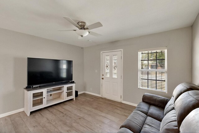 1508 E Dellis St, Kaufman, TX 75142 - living room with a ceiling fan, light wood-style flooring, and baseboards