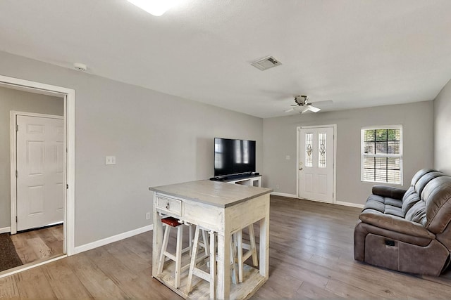 1508 E Dellis St, Kaufman, TX 75142 - living room featuring wood finished floors, baseboards, and a ceiling fan