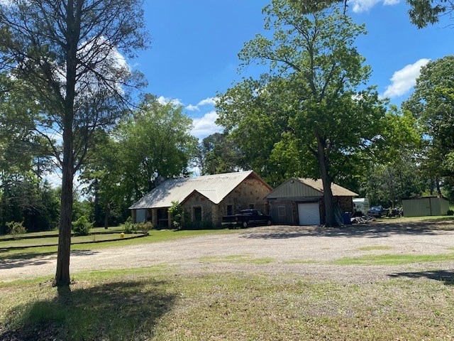 610 Old Tyler Hwy, Athens, TX 75751 - ranch-style house featuring a garage, an outdoor structure, a front yard, and view of scattered trees
