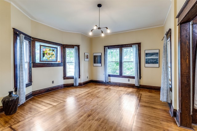 5020 Junius St, Dallas, TX 75214 - empty room with crown molding, wood finished floors, and a chandelier