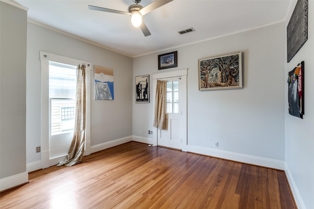 5020 Junius St, Dallas, TX 75214 - empty room featuring light wood finished floors, crown molding, and a ceiling fan