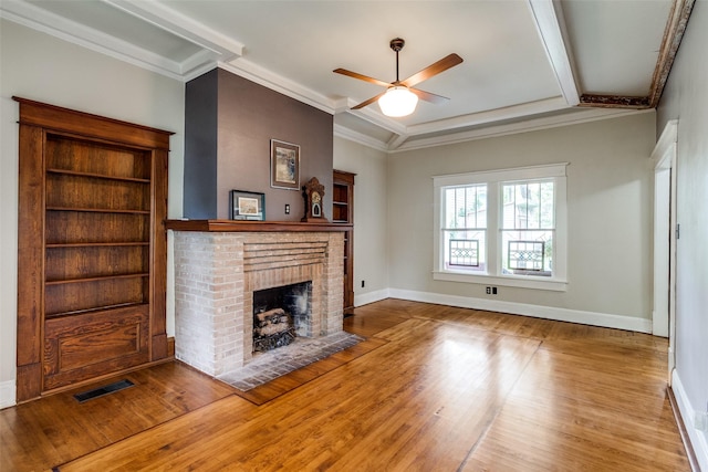 5020 Junius St, Dallas, TX 75214 - unfurnished living room with wood finished floors, a fireplace, a ceiling fan, and crown molding