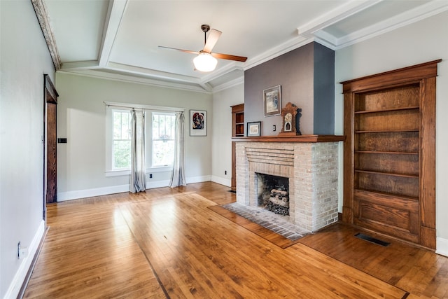 5020 Junius St, Dallas, TX 75214 - living area featuring a fireplace, wood finished floors, a ceiling fan, and crown molding