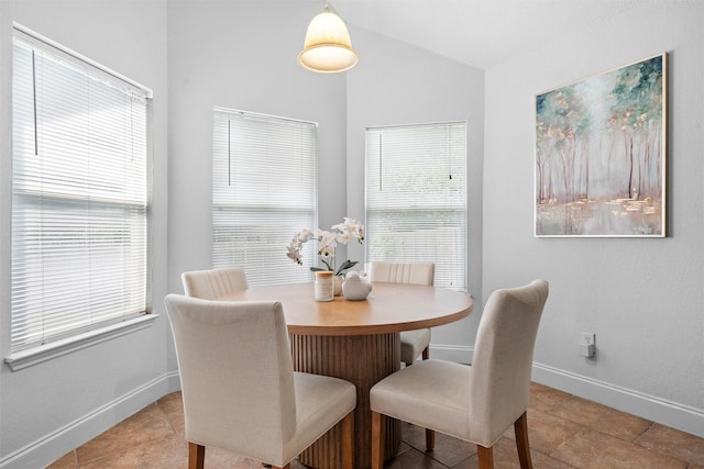 1115 Cherrytree Dr, Arlington, TX 76001 - dining area featuring baseboards, vaulted ceiling, and light tile patterned floors