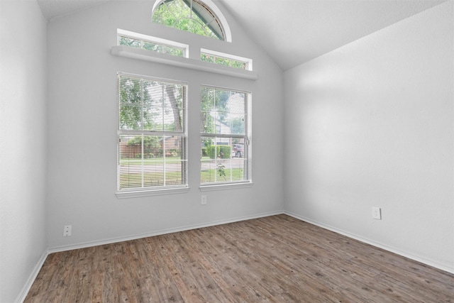 1115 Cherrytree Dr, Arlington, TX 76001 - empty room featuring vaulted ceiling, wood finished floors, and baseboards