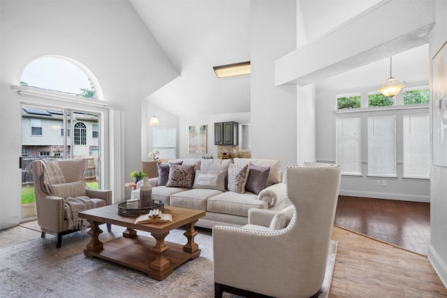 1115 Cherrytree Dr, Arlington, TX 76001 - living area with high vaulted ceiling, hardwood / wood-style flooring, and baseboards