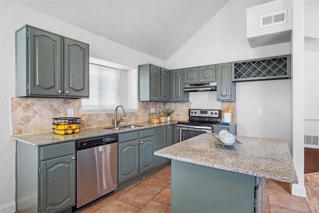 1115 Cherrytree Dr, Arlington, TX 76001 - kitchen featuring a sink, stainless steel appliances, under cabinet range hood, light stone counters, and decorative backsplash