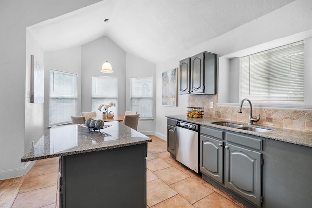1115 Cherrytree Dr, Arlington, TX 76001 - kitchen featuring stainless steel dishwasher, a sink, healthy amount of natural light, vaulted ceiling, and a center island