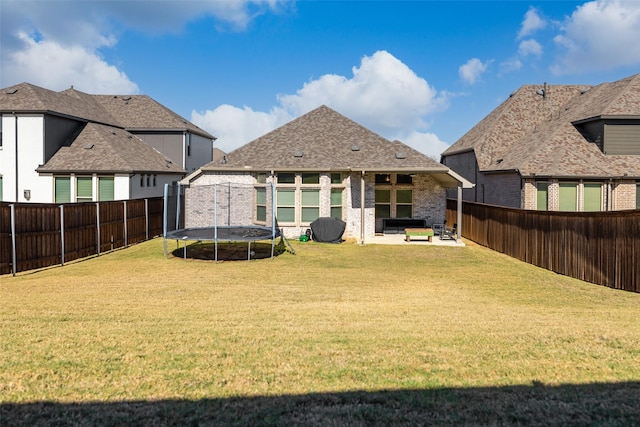 2434 Solomons Pl, Wylie, TX 75098 - rear view of house featuring a trampoline, brick siding, and a patio area