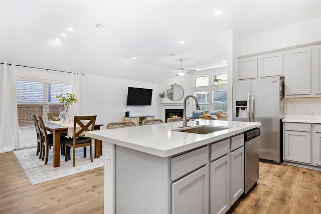 2434 Solomons Pl, Wylie, TX 75098 - kitchen with a sink, stainless steel appliances, light wood-style floors, a ceiling fan, and recessed lighting