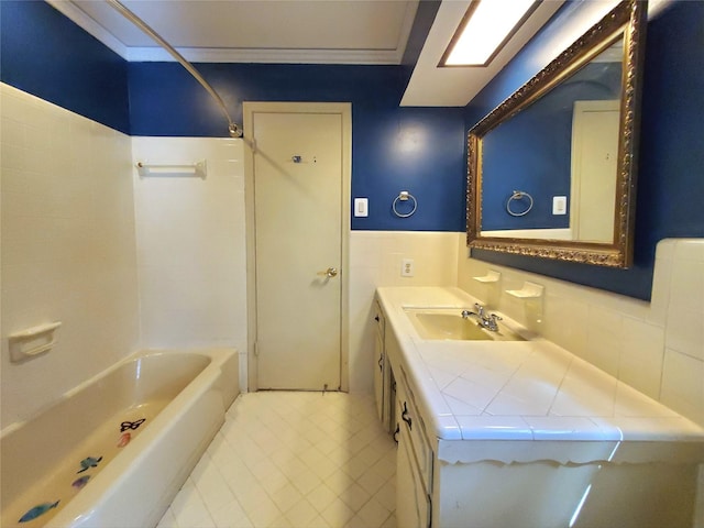912 Chadwick Dr, Richardson, TX 75080 - bathroom featuring tile walls, shower / tub combination, vanity, wainscoting, and tile patterned floors