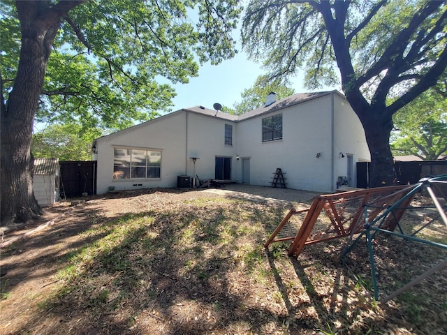 912 Chadwick Dr, Richardson, TX 75080 - back of property featuring fence, cooling unit, and stucco siding