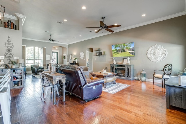 9001 Magnolia Vale Dr, Granbury, TX 76049 - living room featuring ceiling fan, arched walkways, wood finished floors, recessed lighting, and ornamental molding