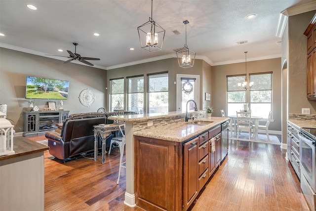 9001 Magnolia Vale Dr, Granbury, TX 76049 - kitchen with a sink, brown cabinets, a chandelier, hardwood / wood-style floors, and recessed lighting