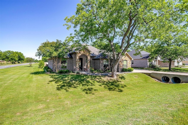 9001 Magnolia Vale Dr, Granbury, TX 76049 - view of front of home featuring a front lawn and stone siding