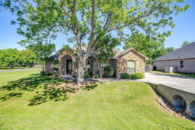 9001 Magnolia Vale Dr, Granbury, TX 76049 - view of front facade with a front yard and brick siding