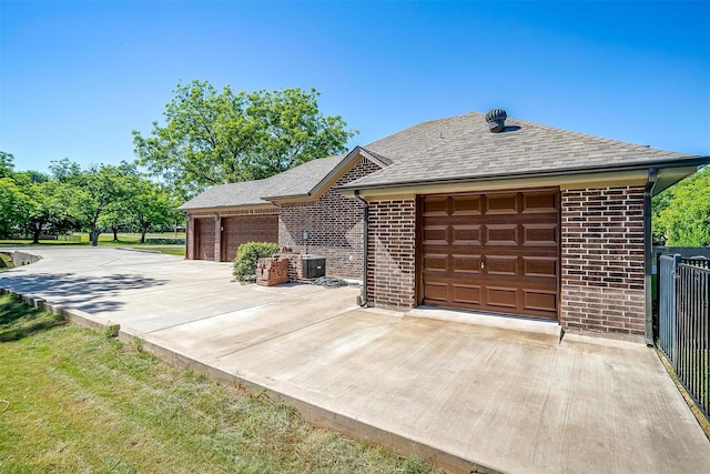 9001 Magnolia Vale Dr, Granbury, TX 76049 - view of front of home with brick siding, central AC unit, a garage, and a shingled roof