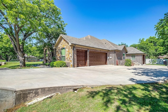 9001 Magnolia Vale Dr, Granbury, TX 76049 - view of front of home featuring a garage, concrete driveway, and stone siding