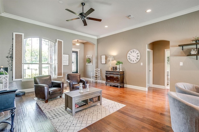9001 Magnolia Vale Dr, Granbury, TX 76049 - living room featuring arched walkways, a ceiling fan, light wood-type flooring, ornamental molding, and recessed lighting
