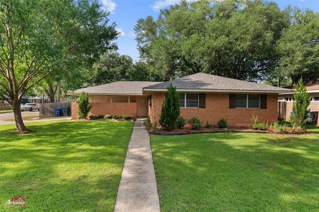 ranch-style house featuring brick siding and a shingled roof