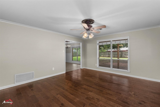 spare room with a ceiling fan, ornamental molding, a chandelier, wood finished floors, and baseboards