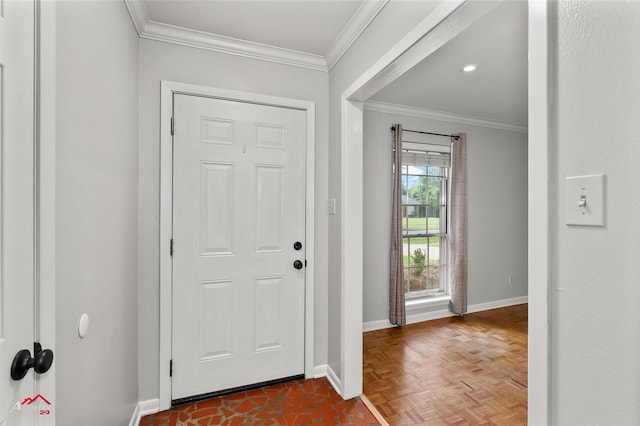 foyer entrance with baseboards and crown molding