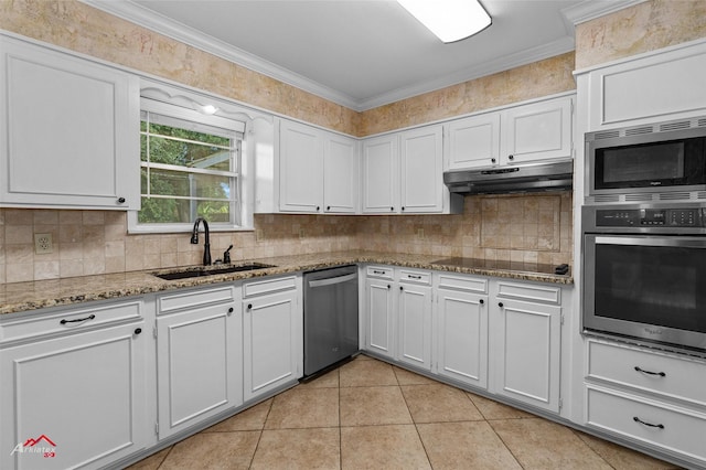 kitchen with appliances with stainless steel finishes, a sink, under cabinet range hood, decorative backsplash, and ornamental molding
