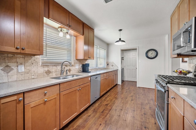 332 Thompson Dr, Saginaw, TX 76179 - kitchen featuring appliances with stainless steel finishes, a sink, dark wood-style flooring, and backsplash
