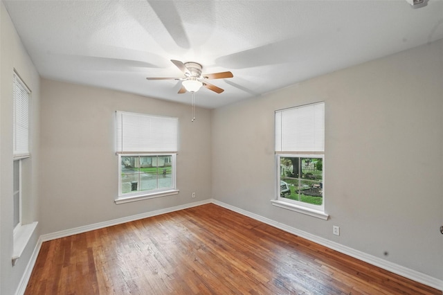 4808 Birchman Ave, Fort Worth, TX 76107 - spare room with a ceiling fan, wood-type flooring, and baseboards