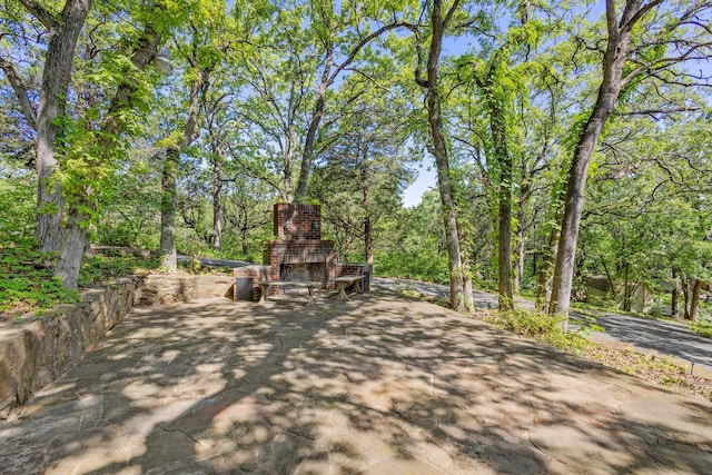 219 Ray Rd, Pottsboro, TX 75076 - view of patio featuring an outdoor stone fireplace and driveway
